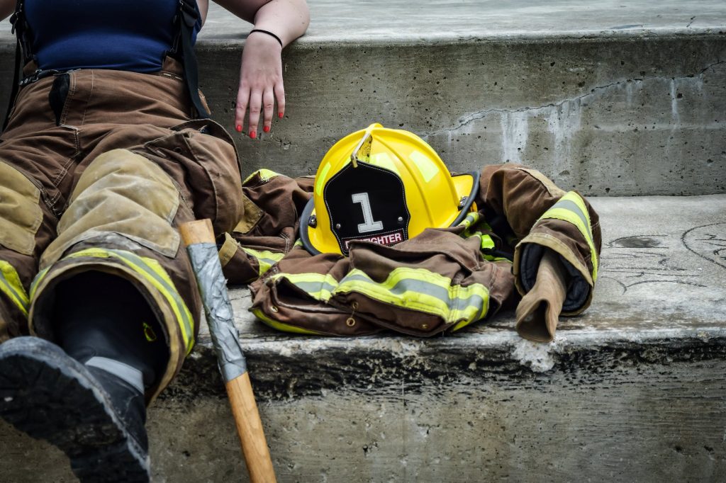 yellow hard hat on brown and yellow fireman s suit