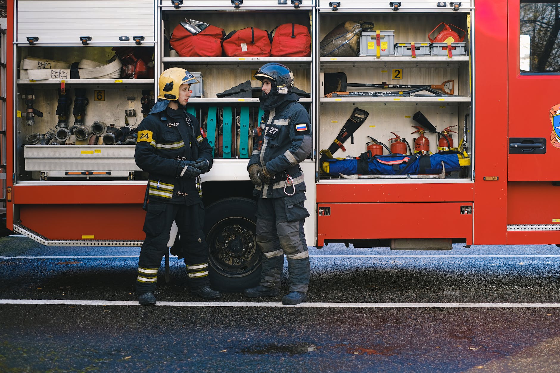 firefighters talking by fire engine