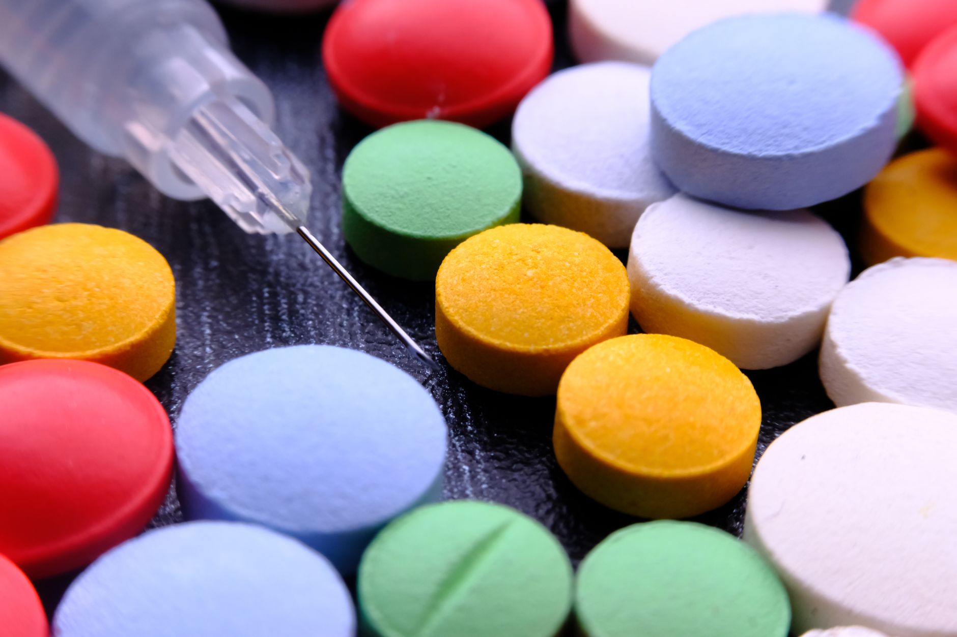 colourful pills and syringe