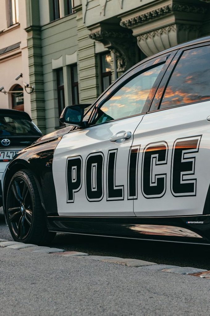 police automobile parked on street sidewalk